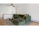 Cozy living room with a plush green sofa, modern rug, and natural light at 2711 S Fenton St, Denver, CO 80227