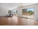 Bright living room with hardwood floors, large windows, and sliding glass doors to a backyard deck at 2711 S Fenton St, Denver, CO 80227