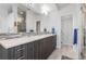 Modern bathroom featuring double sink vanity with grey cabinets and contemporary finishes at 3207 W 25Th Ave, Denver, CO 80211