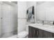 Modern bathroom with a glass shower, white tiles, and stylish vanity at 3207 W 25Th Ave, Denver, CO 80211