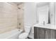 Bathroom featuring a shower and bathtub combo with tile surround and a modern vanity at 3207 W 25Th Ave, Denver, CO 80211