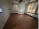 Hardwood floor living room with large windows and a ceiling fan at 701 S Pecos St, Denver, CO 80223