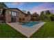 Expansive backyard featuring a sparkling pool, a spa, a well-manicured lawn, and a brick home at 92 S Devinney St, Golden, CO 80401