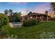 Stunning backyard with a brick home, lush greenery, a pool, and a cozy fire pit for relaxation at 92 S Devinney St, Golden, CO 80401