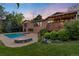 Inviting backyard features a sparkling pool, fire pit, deck, and lush landscaping at 92 S Devinney St, Golden, CO 80401