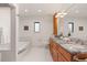 Bathroom featuring granite countertops, tub, tile flooring, and wood cabinets at 92 S Devinney St, Golden, CO 80401