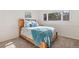 The bedroom showcases a window with tree views and a cozy bed with an ocean-themed color palette at 92 S Devinney St, Golden, CO 80401