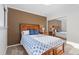 The bedroom features a mirrored closet, natural light, and a wooden bedframe with soft carpeting at 92 S Devinney St, Golden, CO 80401