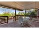 Covered deck with seating area overlooking well-maintained yard with a swimming pool, perfect for relaxation at 92 S Devinney St, Golden, CO 80401