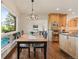 Bright dining area with wood floors, modern chandelier, and a view of the pool at 92 S Devinney St, Golden, CO 80401