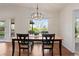 Elegant dining room with a stylish light fixture and a view of the outdoor greenery through a large window at 92 S Devinney St, Golden, CO 80401