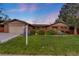 Inviting brick home with well-manicured lawn and landscaped garden beds, showcasing a serene and welcoming curb appeal at 92 S Devinney St, Golden, CO 80401