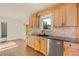Well-lit kitchen with custom wood cabinets, granite countertops, and stainless steel appliances at 92 S Devinney St, Golden, CO 80401