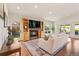 Bright living room featuring hardwood floors, a cozy fireplace, built-in shelving, and sliding glass doors to the backyard at 92 S Devinney St, Golden, CO 80401