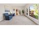 Spacious living room with neutral carpet, two accent chairs, and views of the deck at 92 S Devinney St, Golden, CO 80401