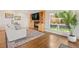 Cozy living room features hardwood floors, a fireplace, built-in shelves, and a sunlit window at 92 S Devinney St, Golden, CO 80401