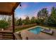 Overhead view from the covered deck of a sparkling pool, inviting spa, and a cozy fire pit area at 92 S Devinney St, Golden, CO 80401