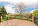 Back deck with railings overlooking a picturesque green space and mature trees at 8525 E 149Th Dr, Thornton, CO 80602