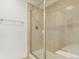 Tiled shower features a glass door, built-in bench, and shower head at 8525 E 149Th Dr, Thornton, CO 80602