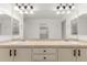 Bright bathroom showcases a large mirror, double sinks and dark hardware at 8525 E 149Th Dr, Thornton, CO 80602