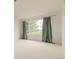Bright bedroom with large window and neutral carpet and walls at 8525 E 149Th Dr, Thornton, CO 80602