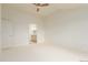 Spacious bedroom with a glimpse of a bathroom, featuring neutral decor and carpet at 8525 E 149Th Dr, Thornton, CO 80602
