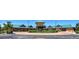 Beautiful clubhouse with a circular driveway, green roof, and well-manicured landscaping at 8525 E 149Th Dr, Thornton, CO 80602