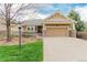 Charming home with a manicured lawn and neutral exterior with an attached two car garage at 8525 E 149Th Dr, Thornton, CO 80602