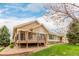 Charming home with a deck and a well-maintained lawn surrounded by greenery at 8525 E 149Th Dr, Thornton, CO 80602