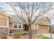 Home featuring stone accents, a well-manicured lawn, and a charming front porch at 8525 E 149Th Dr, Thornton, CO 80602