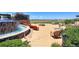 Outdoor patio with stone waterfall, mountain views, fire pit, and stylish seating at 8525 E 149Th Dr, Thornton, CO 80602