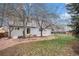 Large backyard featuring a covered patio, mature trees, and lawn at 613 Rio Rancho Way, Brighton, CO 80601
