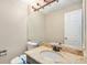 Half bathroom featuring granite countertops, vanity, toilet, lighting, and neutral wall color at 613 Rio Rancho Way, Brighton, CO 80601