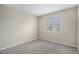 Bright bedroom featuring neutral walls, carpet and a large window at 613 Rio Rancho Way, Brighton, CO 80601