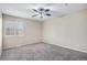 Bright bedroom featuring neutral walls, carpet and a decorative ceiling fan at 613 Rio Rancho Way, Brighton, CO 80601