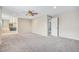 Bright main bedroom with ceiling fan, neutral paint and carpet, and adjoining bathroom at 613 Rio Rancho Way, Brighton, CO 80601
