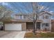 Charming two-story home featuring brick accents, blue shutters, and a well-maintained front yard with mature trees at 613 Rio Rancho Way, Brighton, CO 80601