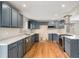 Modern kitchen features updated cabinetry, countertops, stainless steel appliances, and hardwood floors at 613 Rio Rancho Way, Brighton, CO 80601