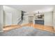 Inviting living room boasts hardwood floors, open staircase, and a seamless open floor plan to the kitchen at 613 Rio Rancho Way, Brighton, CO 80601