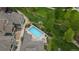 Aerial view of the community pool and hot tub surrounded by lush greenery at 7130 Simms St # 206, Arvada, CO 80004