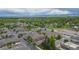 Aerial view of a residential neighborhood with tree lined streets and well-kept lawns at 7130 Simms St # 206, Arvada, CO 80004