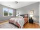 Cozy bedroom with a large window, stylish decor, hardwood floors and soft natural light at 7130 Simms St # 206, Arvada, CO 80004