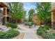 Sidewalk between the colorful townhomes surrounded by green landscaping at 7130 Simms St # 206, Arvada, CO 80004