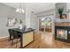 Dining room featuring modern table with fireplace and sliding door to the balcony at 7130 Simms St # 206, Arvada, CO 80004