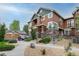 Beautiful townhome with stone accents, a private balcony, and a detached garage at 7130 Simms St # 206, Arvada, CO 80004