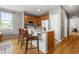 Bright kitchen with bar stool seating, wood cabinets, stone countertops, and stainless appliances at 7130 Simms St # 206, Arvada, CO 80004