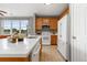 Bright kitchen with wood cabinets, stone countertops, and stainless steel appliances at 7130 Simms St # 206, Arvada, CO 80004