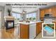 Bright kitchen featuring an island with a white countertop, wood cabinets, and a cozy fireplace at 7130 Simms St # 206, Arvada, CO 80004