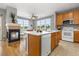 Bright kitchen with a center island, a cozy fireplace, and stainless steel appliances at 7130 Simms St # 206, Arvada, CO 80004