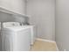 Laundry room featuring a side-by-side washer and dryer with tile floors at 7130 Simms St # 206, Arvada, CO 80004